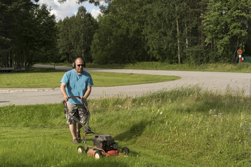 Man cutting his lawn with a mower