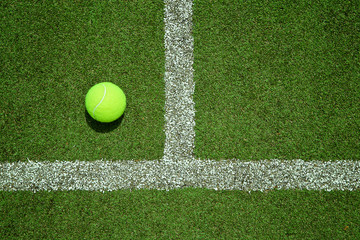 tennis ball near the line on tennis grass court good for backgro