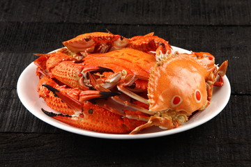 Boiled crab dish on dark background,