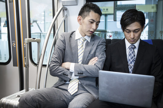 Businessman is using a laptop on a train