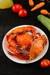 Overhead view-Boiled crab dish on dark background,