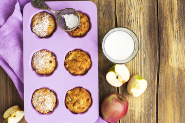 Apple cupcakes over wooden table