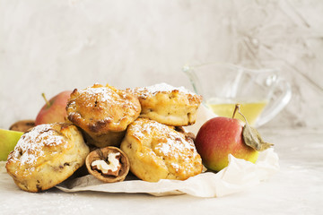 Pile of apple and walnut cupcakes over stone background
