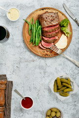 Sliced medium rare grilled steak with red wine