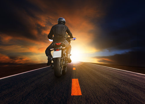 young man riding big motorcycle on asphalt highway use for peopl