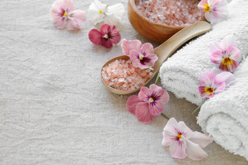 Pink sea salt and flowers, Spa setting, copy space background