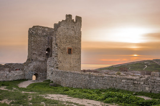 the ruins of the ancient fortress at sunset