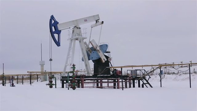 Oil and gas industry. Work of oil pump jack on a oil field. Perfect for shots requiring energy, oil, enegy policy.