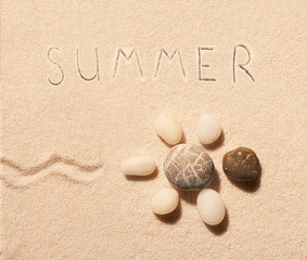 Fototapeta na wymiar Turtle of sea stones and summer lettering on sand