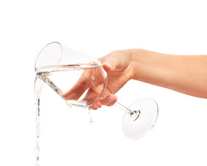 Water pouring from full wine glass in woman's hand © IntelWond