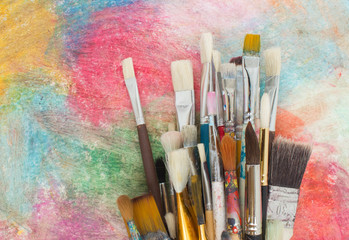 Fototapeta premium Brushes on a colorful background. The workplace of the artist. Banner for school