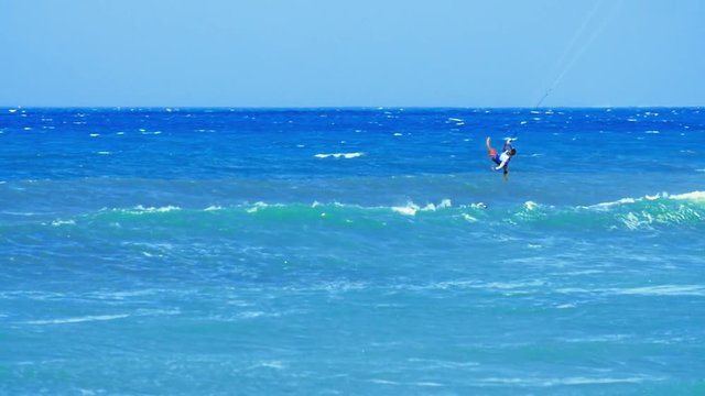 Summer ocean sport video. Active man kitesurfing on sea