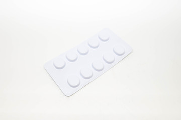 white pils tablets in blister pack isolated on white background.