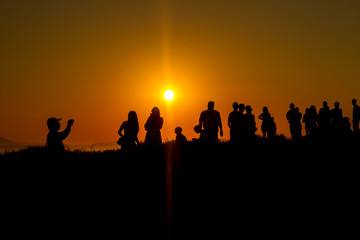 tourist group on the mountain in Greece during sunset