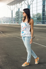 lifestyle portrait young woman walking on the street with backpa