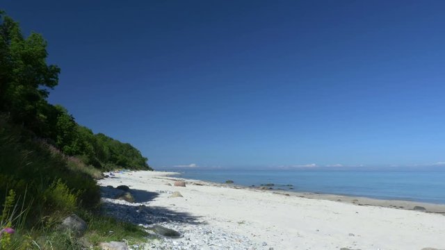 Beach scene with blue sky. Rügen - Baltic Sea. Clip contains beach, baltic sea, ruegen, sandy beach, beautiful, blue, water, sea, sunny.
