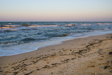 sea, waves, sandy beach and sunset