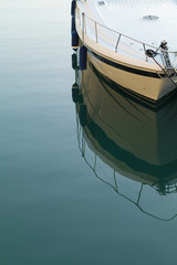 White Luxury yacht with reflection calm blue Mediterranean water