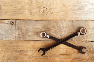 wrenches on the wooden background.