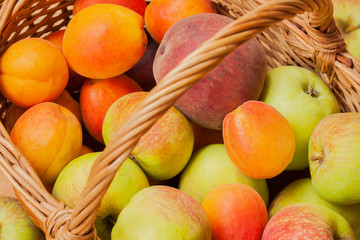 Summer ripe fruit in a wicker basket close-up