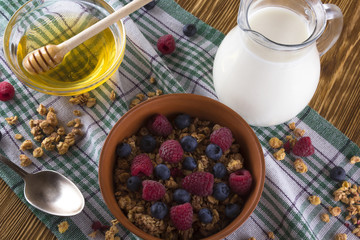Muesli with fresh berries, honey and milk.