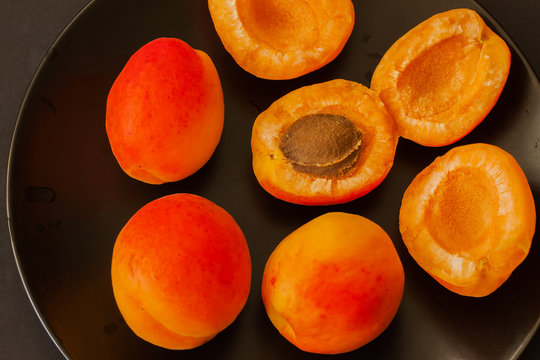 Bright apricots on black background, close-up