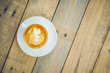 Top view of coffee cup on wooden table