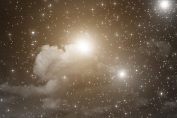 Stars on a dark sky with some clouds.