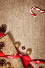 Christmas decoration background over linen background. Vertical photo taken from above, top view with copy space for text and other web or print design elements.