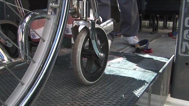 Wheelchair being placed on ramp