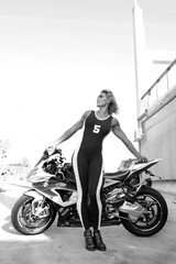 Fototapeta na wymiar Very strong girl stay beside the sport motorcycle