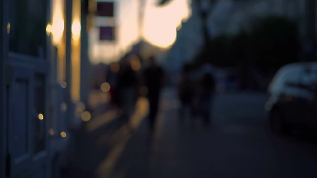 Out of focus background and unrecognizable people walking around the city