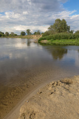 Obraz premium Nice country panorama with river, sheep and green field