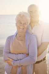 Portrait of embracing senior marriage on the beach