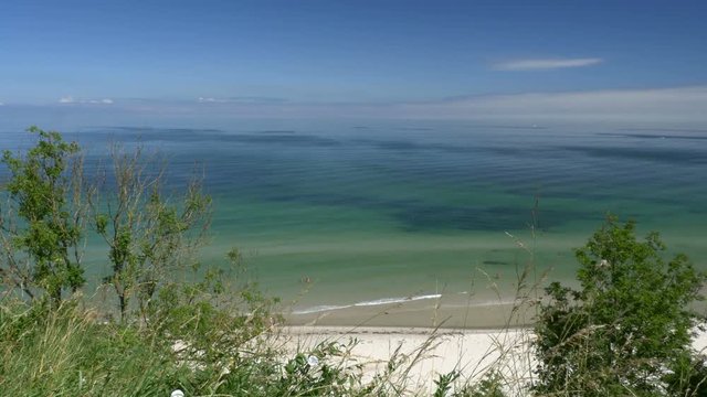 Beach view from cliff. Blue sky. R&uuml;gen - Baltic Sea. Clip contains beach, baltic sea, ruegen, sandy beach, beautiful, blue, water, sea, sunny.