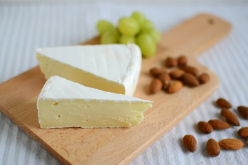 Brie cheese in wooden plate