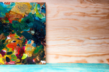 Painting palette on wooden background