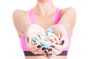 Close-up of woman holding pills or supplements