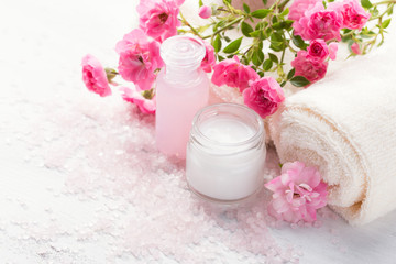 Spa setting with   branch of  small  pink roses.  Selective focus
