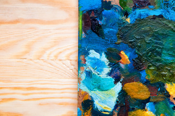 Painting palette on wooden background