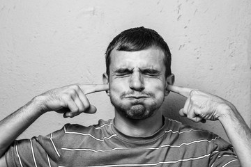 young man with beard with different emotions. black and white photo. emotional card. close up of a funny young man.  misunderstanding