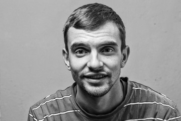 young man with beard with different emotions. black and white. emotional card. close up of a funny young man.