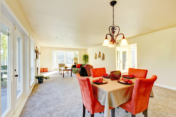 Spacious creamy tones interior of family room and dining room.