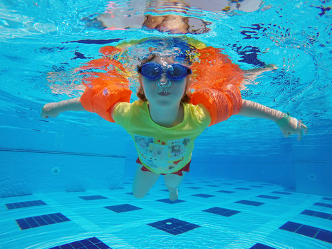 Little Girl Swimming In The Pool