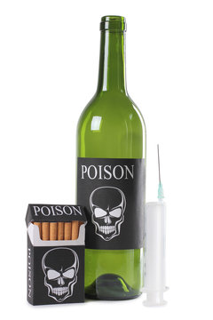 Cigarettes, wine and a syringe on a white background