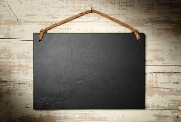 black slate signboard on aged wall