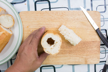 Hand with knife penetrate bread