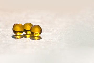 fish oil capsules/ fish oil capsules on a pink background