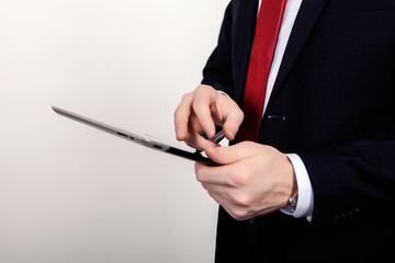 close up of businessman touch tablet or ipad in hand