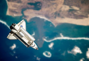 Space Shuttle orbiting the earth. Elements of this image furnish